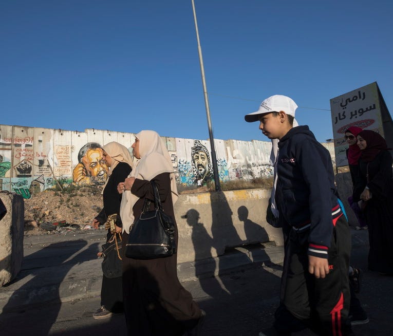 Palestinians from West Bank go through Qalandia checkpoint on their way to Jerusalem, May 18, 2018.