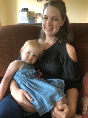 Amy Marchant, with her daughter Autumn, at home in Brighton. Marchant settled a lawsuit with The Naz - Brighton's Nazarene Church, earlier this month. She was criticized in 2018 by a church staff member while breastfeeding inside the church.