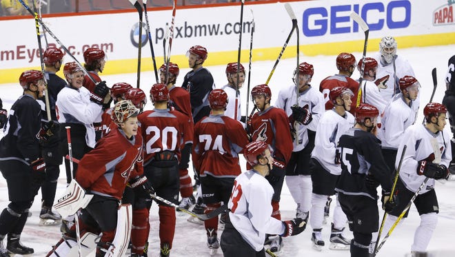 The Arizona Coyotes celebrate the end of practice during rookie camp Saturday, September 17, 2016 in Glendale.