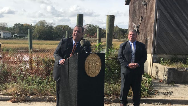 Gov. Chris Christie talks about New Jersey's expansion of its Blue Acres program. Keansburg Mayor George Hoff stands behind him.