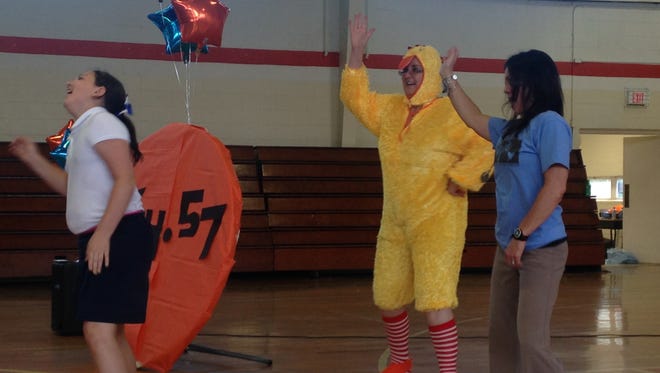 Judy Record, the principal of East Elementary School, danced in a chicken suit as part of the school's Relay for Life assembly Monday.