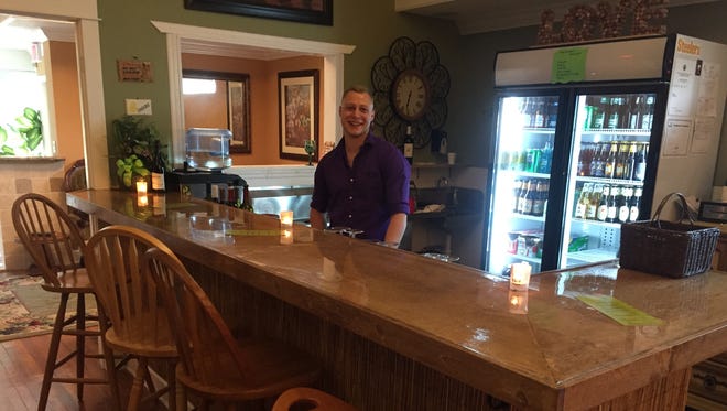 Bartender Austin Coen is ready to serve patrons at NOTES Wine Bar & Music Room in downtown Stuart.