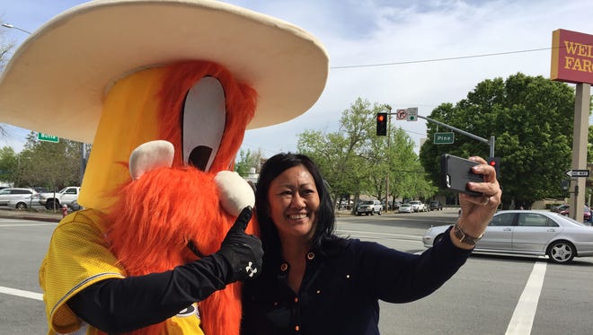 Julie Hunt of Redding got a free pair of tickets to a Colt 45s baseball game for taking a selfie with the team's un-named mascot Wednesday outside the Redding Chamber of Commerce office.