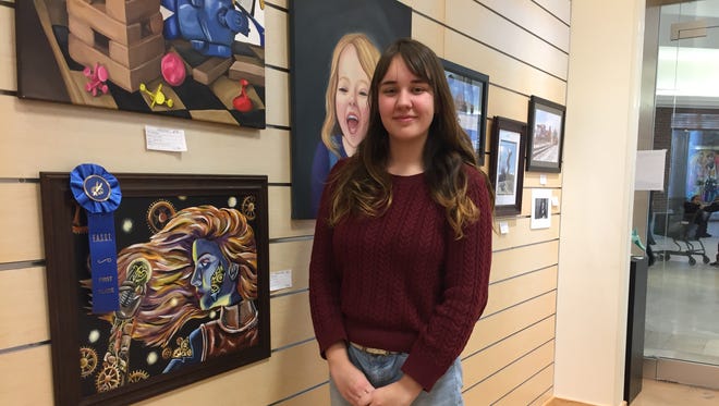 Owego Free Academy senior Larissa Hankey with her painting "Switching Gears," which took first place for painting in the Fine Arts Society of the Southern Tier's Young at Art Show and Competition in March.