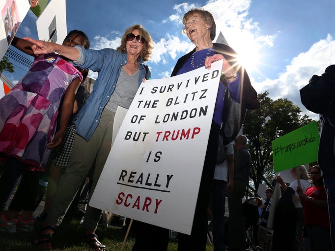 Enid Pensack, of Pennington, N.J., holds a sign as