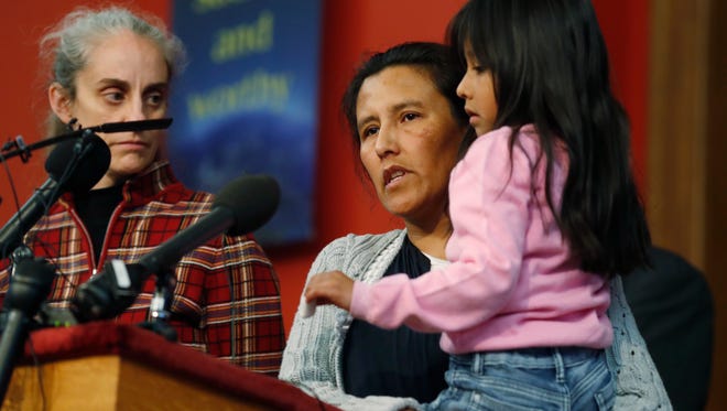 Jeanette Vizguerra, a Mexican woman seeking to avoid deportation from the United States, center, speaks as she holds her 6-year-old daughter, Zuri, right, while Jennifer Piper, left, of the American Friends Service Committee, looks on during a news conference in a church in which Vizguerra and her children have taken refuge, Wednesday, Feb. 15, 2017, in Denver. U.S. immigration authorities have denied the her request to remain in the country.