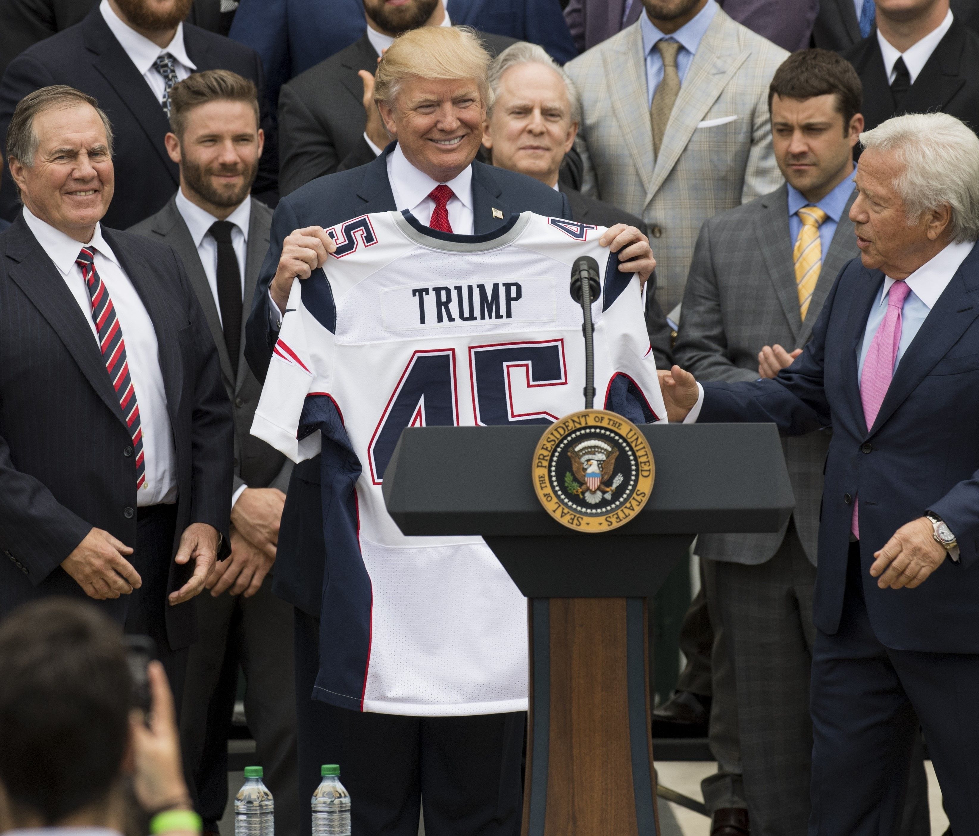 President Donald Trump holds a jersey given to him by New England Patriots owner Robert Kraft and head coach Bill Belichick alongside members of the team during a ceremony honoring them as 2017 Super Bowl Champions on the South Lawn of the White Hous