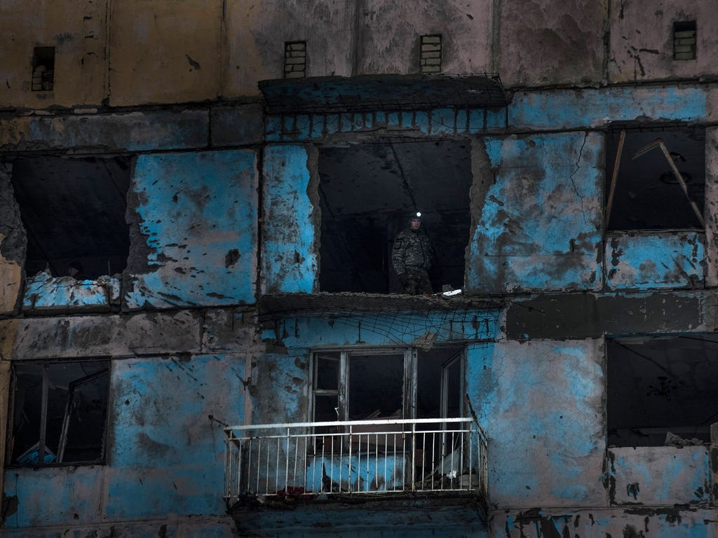 A Ukrainian fighter of the Right Sector battalion stands in a building damaged by shelling in Avdiivka, Ukraine, on Feb. 4, 2017.  Fighting in eastern Ukraine sharply escalated this week. The Ukrainian command said Saturday that several soldiers were