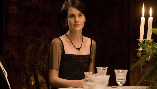 Lady Mary Crawley (played by Michelle Dockery) in a scene from “Downton Abbey.” If you are throwing a “Downton” party remember: no hats for women after 5 p.m., and no gloves at the table.