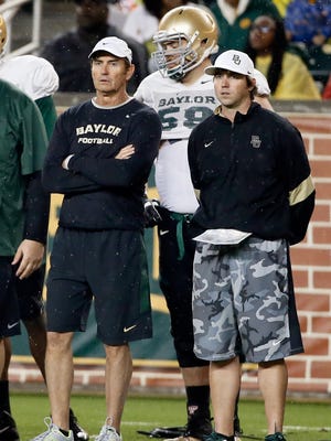 In this March 20, 2015, file photo, then-Baylor coach Art Briles, left, and offensive coordinator Kendal Briles, right, watch a play during the team's NCAA college football intrasquad scrimmage in Waco, Texas. Baylor has kept intact its assistant coaching staff after firing coach Art Briles despite an investigation's multiple findings that football coaches had inappropriate conduct and influence in school assault investigations.