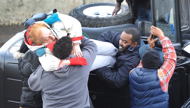 Detroit News photographer Daniel Mears took first place in the News Photography category for his photo “Good Samaritans to the rescue” at the Detroit chapter of the Society of Professional Journalists awards ceremony.