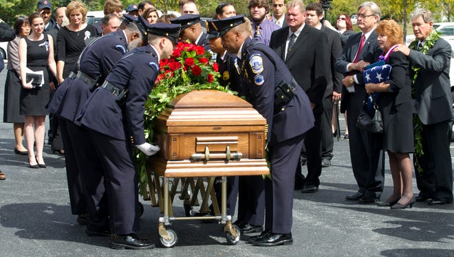 Washington D.C. metropolitan police officers carry the coffin of Richard Michael Ridgell, 52, of Westminster, Md. after his funeral service at The Church at Severn Run, in Severn, Md.