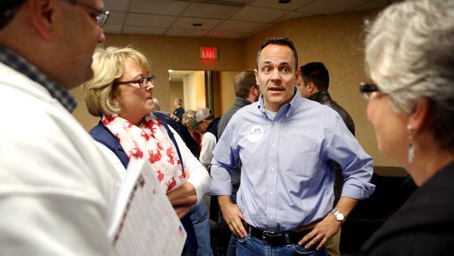 Matt Bevin, Republican candidate for Kentucky Governor, talks Pam Zimmerman, Steve Knipper and Kelley Westwood at the Kenton County GOP office in Fort Wright Saturday, October 31, 2015.