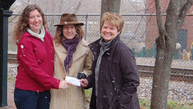 Sarah Vekasi (from left) and Martha Johnson, members of the Old Depot Association board, received Seed Money from Lisa Wasoski, chair of the Seed Money Committee.