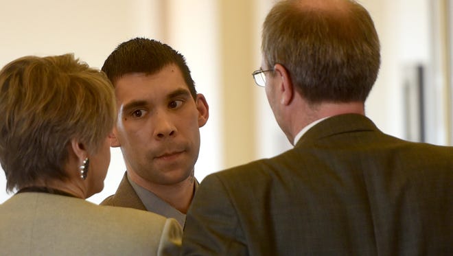 Cody Soto talks with his defense attorneys during a break on Wednesday at the Eleventh Judicial District Court in Aztec during his trial on a charge of murder.