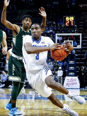 University of Memphis guard Jeremiah Martin (right) drives the lane against the University of South Florida defense during first-half action at the FedExForum.