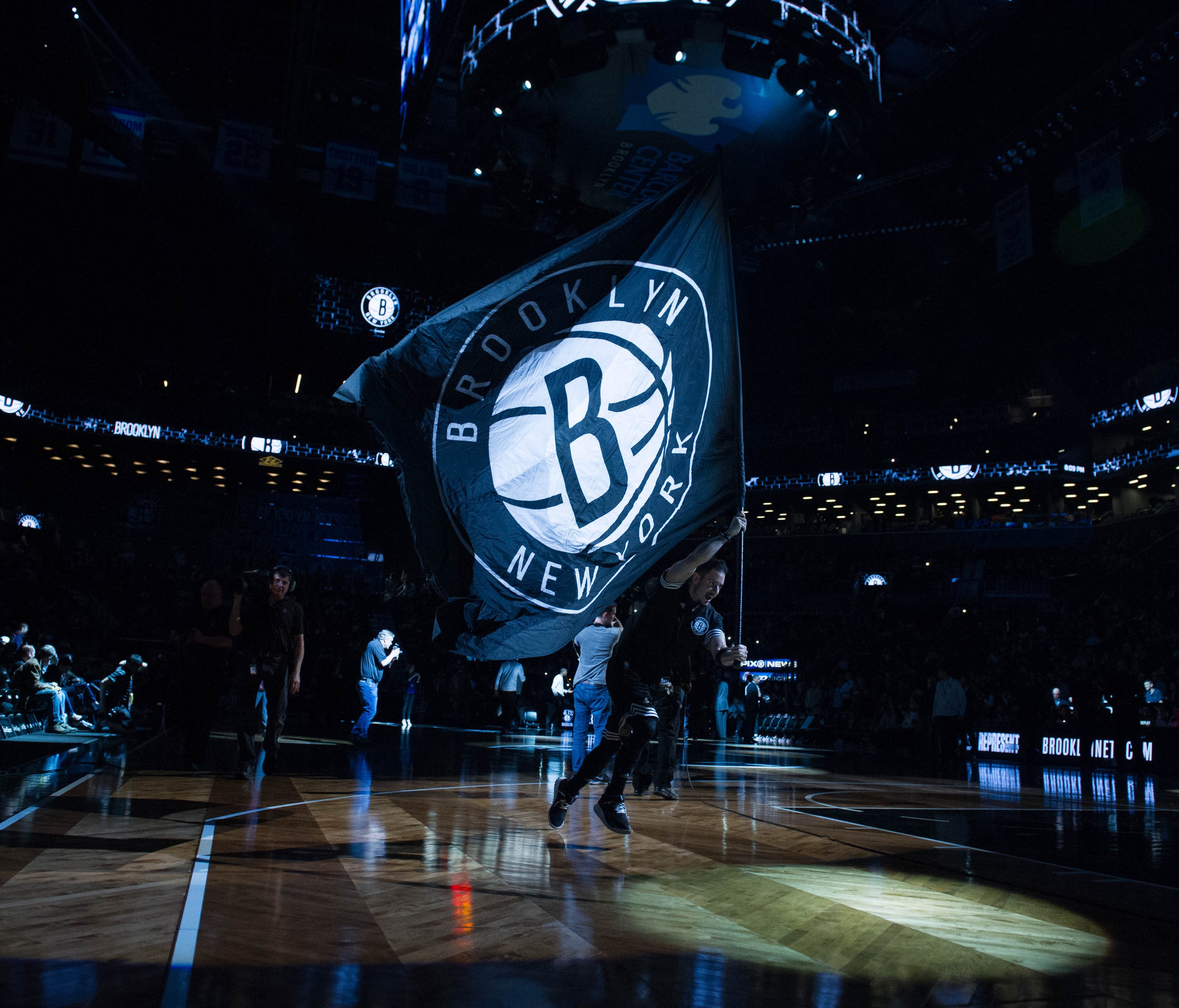 The Brooklyn Nets flag is run across the court in the first half at Barclays Center. Milwaukee defeats Brooklyn 109-100.