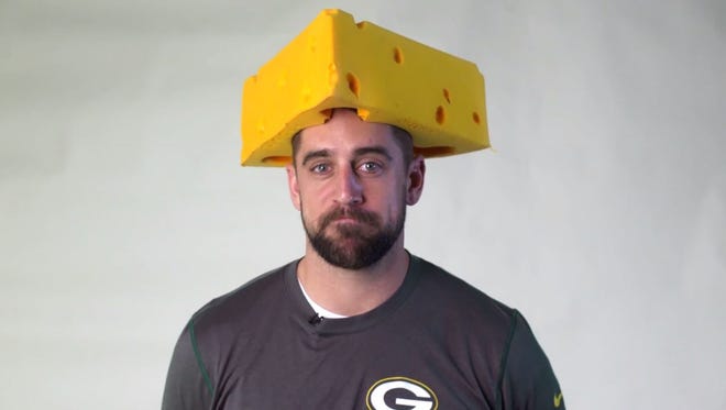 Green Bay Packers quarterback Aaron Rodgers dons a Cheesehead to help raise money for Enough’s Raise Hope for Congo campaign.
