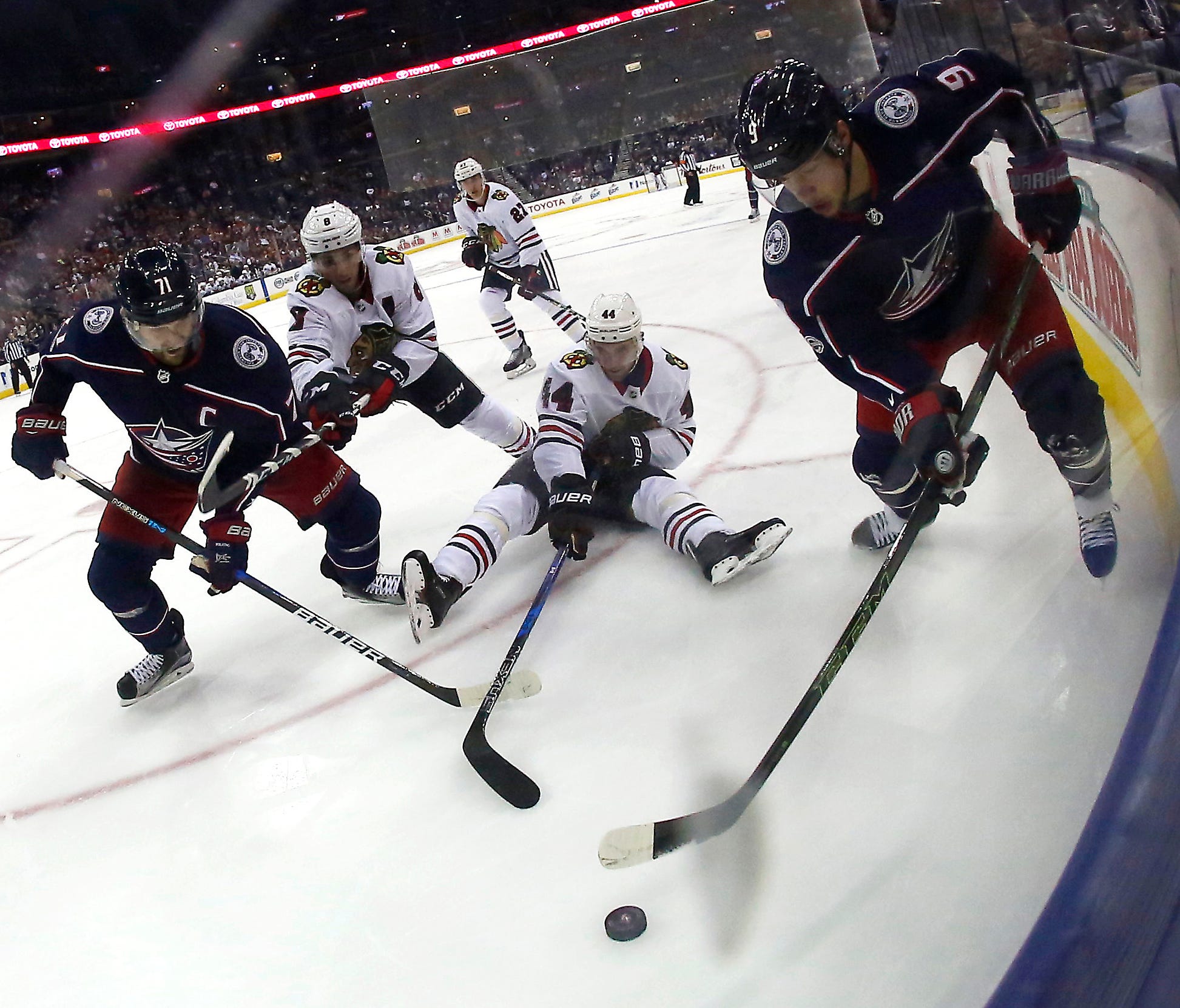 Columbus Blue Jackets left wing Nick Foligno (71) and teammate Artemi Panarin (9) defend Chicago Blackhawks defenseman Jan Rutta (44) during the first period at Nationwide Arena.