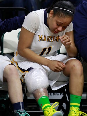 Goodrich's Tania Davis sits on the bench with ice other knee after being injured in the fourth quarter of their 69-39 loss to Birmingham Detroit Country Day in Class B semifinal game on Friday in East Lansing.