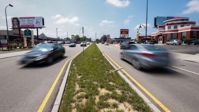 A median installed in 2013 has reduced accidents on Kenwood Road, but separates traffic from crossing and reaching businesses on either side.