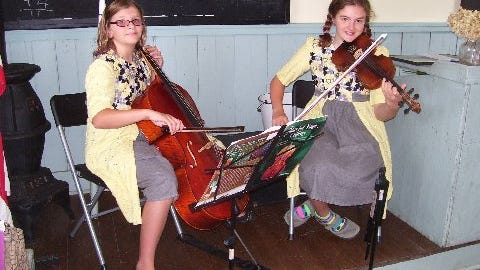 Cosette and Macey Veeder-Shave from Hyde Park performed on their fiddle and cello, respectively, during the recent open house at the Little Red Schoolhouse.