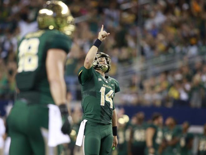 Nov 16, 2013; Arlington, TX, USA; Baylor Bears quarterback Bryce Petty (14) points to the sky after a touchdown was scored in the fourth quarter of the game against the Texas Tech Red Raiders at AT&T Stadium.  Baylor beat Texas Tech 63-34. Mandatory Credit: Tim Heitman-USA TODAY Sports