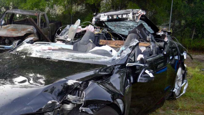 In this photo provided by the National Transportation Safety Board via the Florida Highway Patrol, a Tesla Model S that was being driven by Joshua Brown, who was killed when the Tesla sedan crashed while in self-driving mode on May 7, 2016. A source tells The Associated Press that U.S. safety regulators are ending an investigation into a fatal crash involving electric car maker Tesla Motors' Autopilot system without a recall. The National Highway Traffic Safety Administration scheduled a call Thursday, Jan. 19, 2017, about the investigation. (NTSB via Florida Highway Patrol via AP, File)