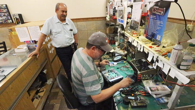 Ricardo Rosario, right, and Joel Rodriguez own and operate Bandidos Radio Shop inside the Petro Stopping Center at I-10 and Horizon Blvd. They cater mostly to truck drivers who depend on CB radios for their work. 