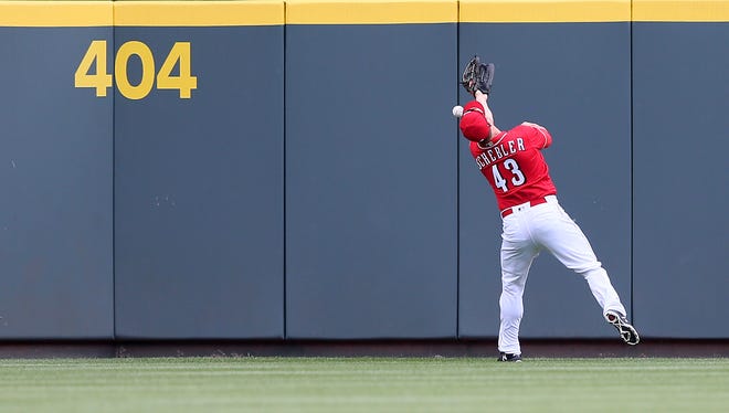 A fly ball sails over the head of Cincinnati Reds right fielder Scott Schebler (43) in the third inning during the National League baseball game between the Washington Nationals and the Cincinnati Reds, Saturday, March 31, 2018, at Great American Ball Park in Cincinnati. 