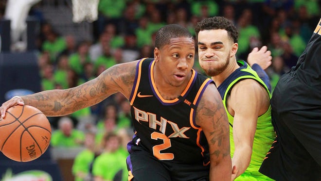 Phoenix Suns guard Isaiah Canaan (2) drives against Minnesota Timberwolves guard Tyus Jones (1) in the first quarter of an NBA basketball game on Saturday, Dec. 16, 2017, in Minneapolis.