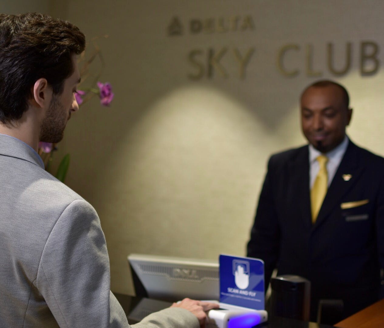 This image provided by Delta shows a biometric fingerprint scan being used to confirm entry at one of the carrier's frequent-flier lounges.