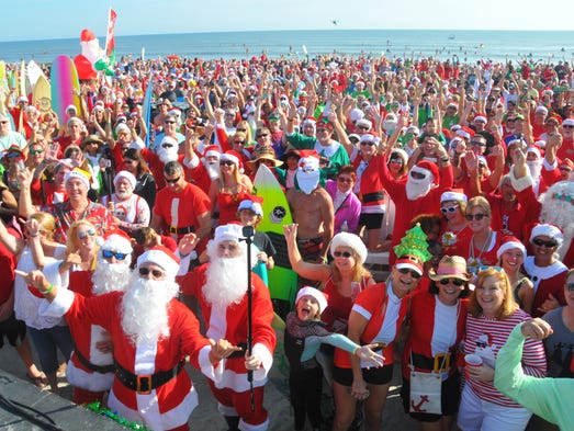 Thousands turned out to watch hundreds of surfing Santas