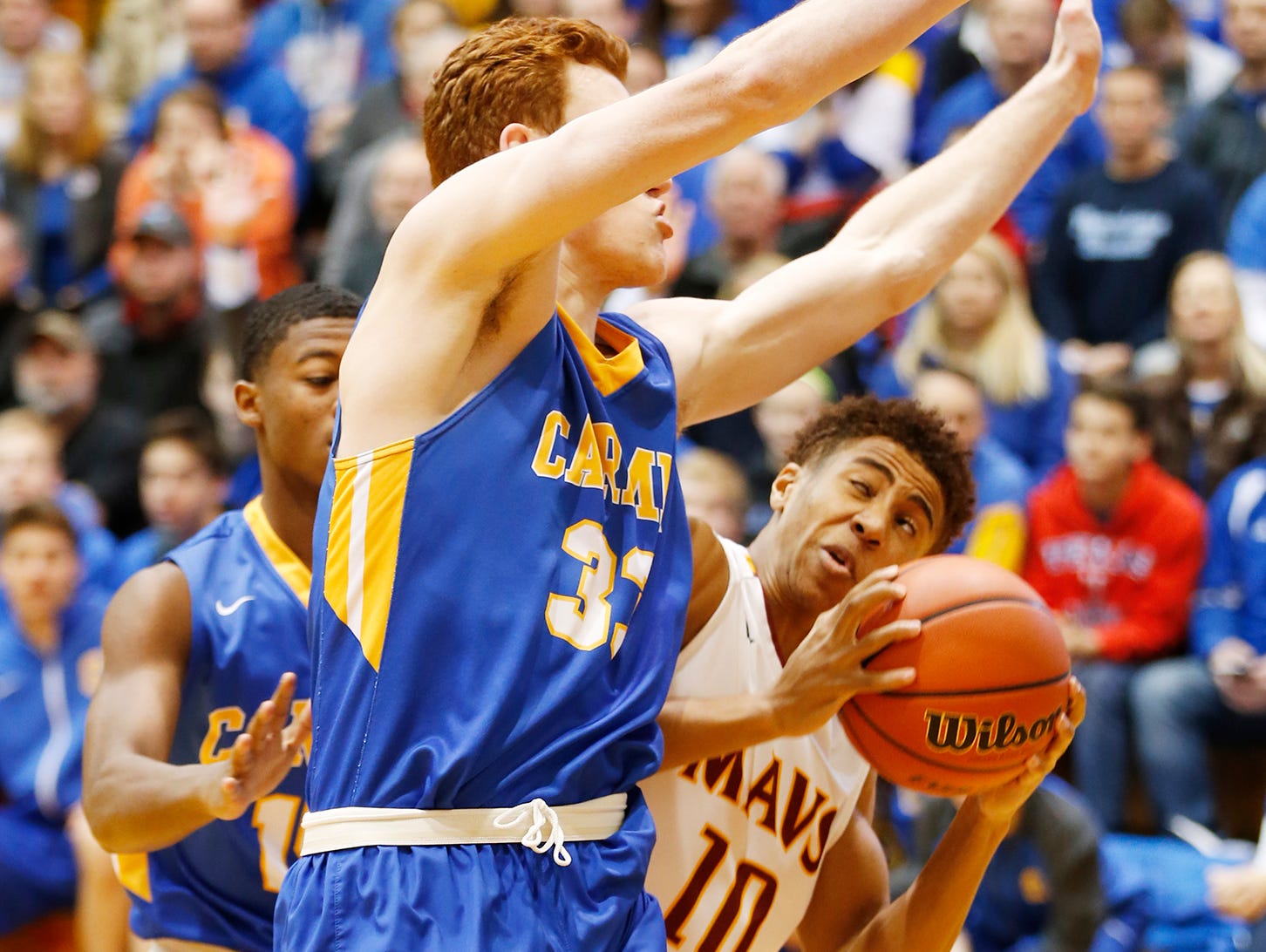 Carmel's John Michael Mulloy blocks the path of McCutcheon's Robert Phinisee in the Greyhounds' regional semifinal win at Logansport. Carmel lost in the final to Fort Wayne North Side.