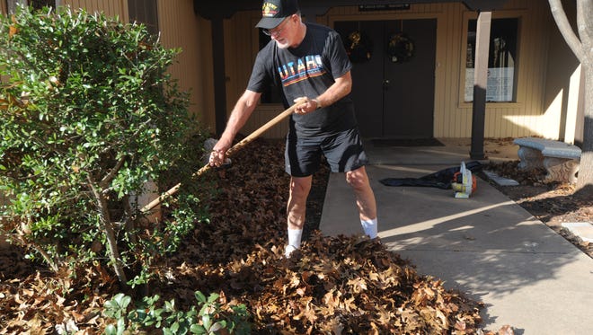Ben Nanny rakes leaves in front of at Grace Lutheran Church. Nanny is congregational vice president at the church and one of his duties is maintaining the property.
