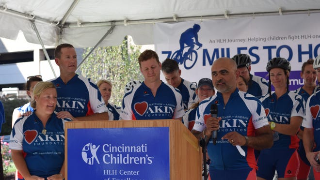 Dr. Ashish Kumar, holding the microphone, speaks Sept. 18 at the end of the fourth annual HLH Ride for Hope, a 700-mile bike ride from Jackson, Mississippi, to Cincinnati Children’s Medical Center. Kumar treats children with the devastating immune disorder.