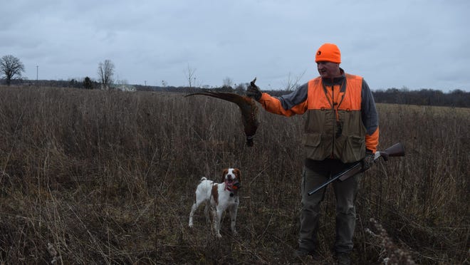 Brian Gross and Ruby admire a late-season Michigan pheasant.