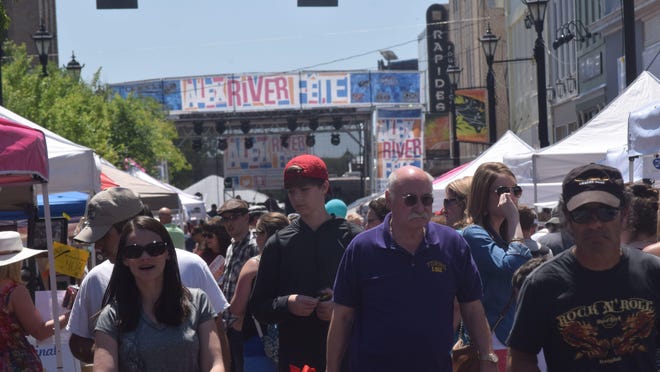Crowds walk along Third Street in downtown Alexandria during a previous year's Alex River Fête.