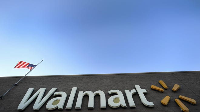 FILE- This Nov. 9, 2018, file photo shows a Walmart Supercenter in Houston. Walmart is extending its debt-free college benefits to high schoolers as a way to attract workers in a tight labor market. It says it will offer free college SAT and ACT prep for its workers in high school, while offering two to three free general education college classes through an educational startup. Walmart estimates about 25,000 people under the age of 18 work at its stores. (AP Photo/David J. Phillip, File)