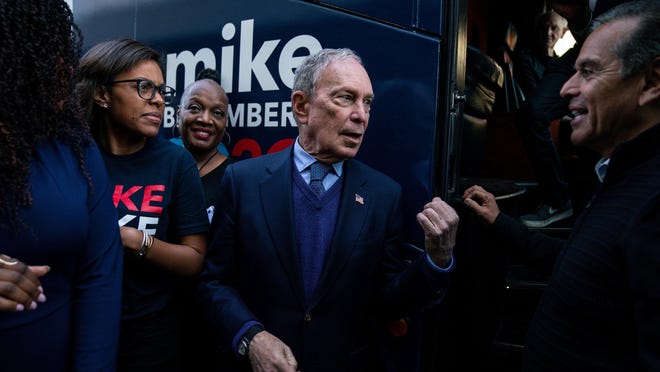 Democratic presidential candidate Michael Bloomberg speaks with former Los Angeles Mayor Antonio Villariagosa after a campaign rally Monday at the Douglas F. Dollarhide Community Center in Compton, Calif.
