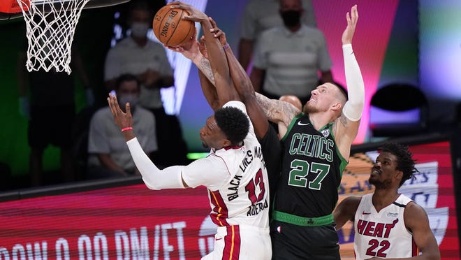 The Celtics' Daniel Theis (27) battles the Heat's Bam Adebayo for the ball during Game 5 of the Eastern Conference finals on Friday in Lake Buena Vista, Fla. Theis recorded a double-double with 15 points and 13 rebounds and helped Boston to a  121-108 victory.