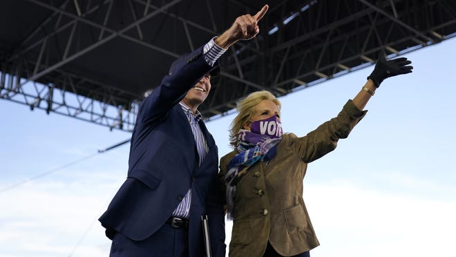 Democratic presidential candidate former Vice President Joe Biden points as his wife Jill Biden waves during a campaign event at Dallas High School in Dallas, Pa., Saturday, Oct. 24, 2020.