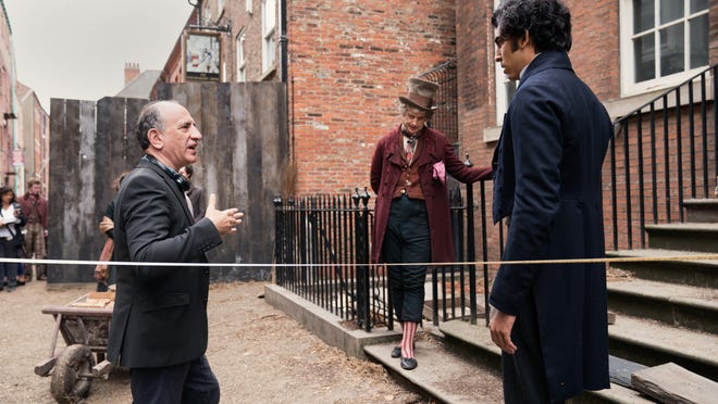 Armando Iannucci gives direction to Dev Patel and Peter Capaldi.