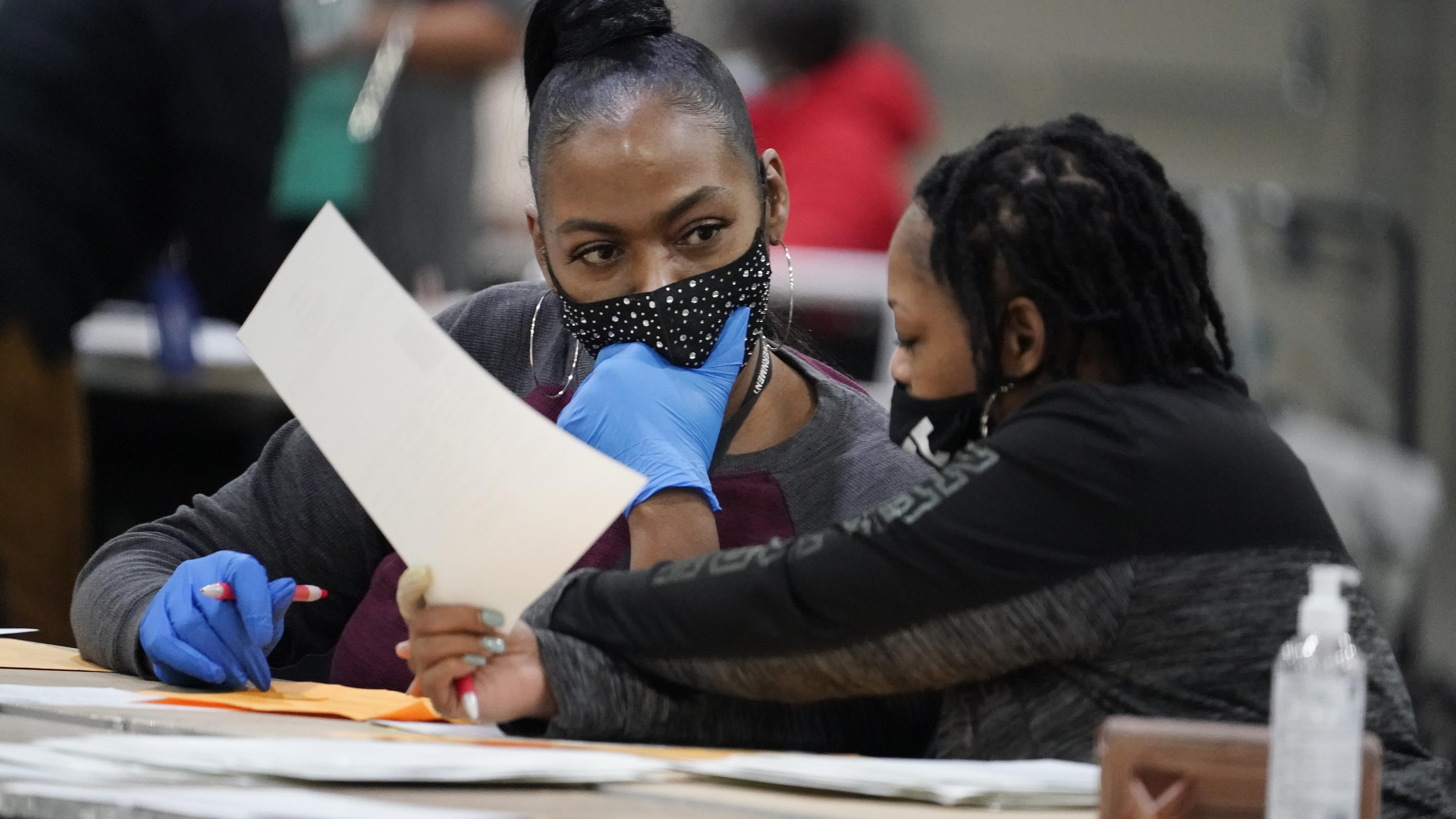 Officials sort ballots during an audit at the Georgia World Congress Center on Saturday, Nov. 14, 2020, in Atlanta.