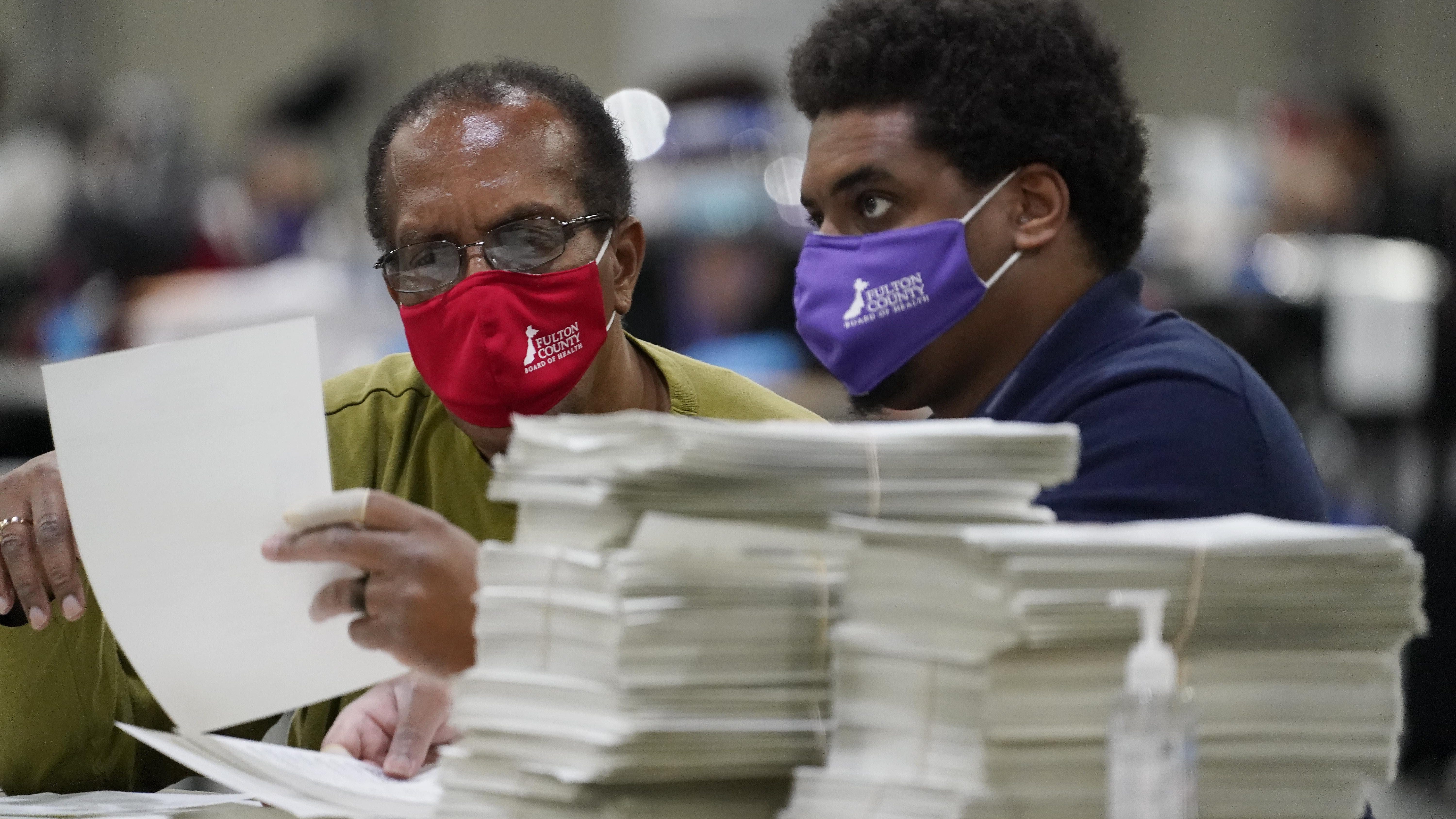 Officials sort ballots during an audit at the Georgia World Congress Center on Saturday, Nov. 14, 2020, in Atlanta.