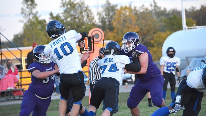 Pickford's Eric Huyck (54) leads the defensive rush against Superior Central quarterback Kyle Frusti (10) in a game this season. The Panthers are ranked No. 1 in the U.P. and state football polls.