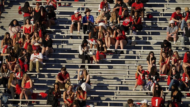 Georgia students gather in the stands before a game between Georgia and Auburn on Saturday night in Athens.