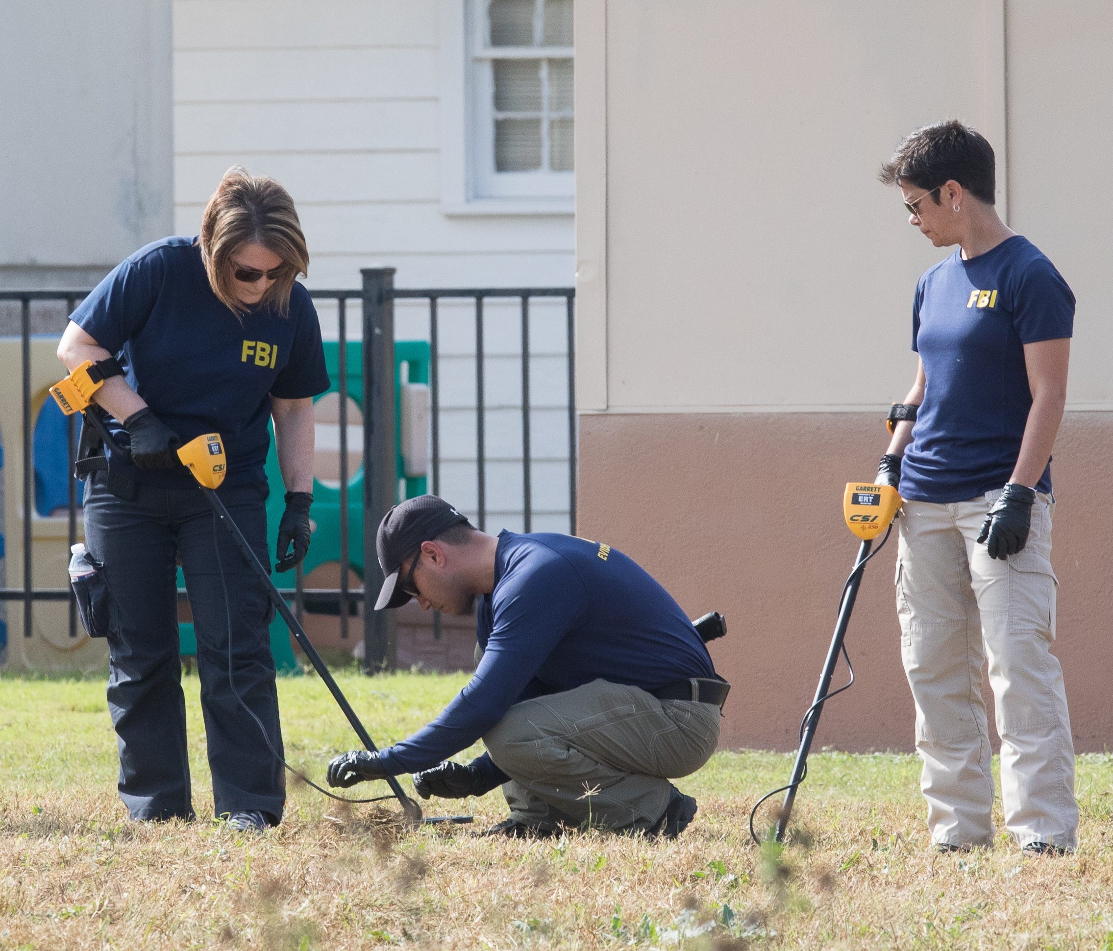 Members of the FBI look for evidence in the field next to the First Baptist Church in Sutherland Springs, Texas on Nov. 6, 2017.