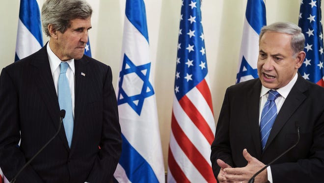 FILE - In this Jan. 2, 2014 file photo, U.S. Secretary of State John Kerry, left, listens as Israeli Prime Minister Benjamin Netanyahu makes a statement during a press conference before their talk at the prime minister's office in Jerusalem. Tuesday, April 29, 2014, was to have been the day to seal a deal on a Palestinian state alongside Israel. Instead, it became another missed deadline in two decades of negotiating failures. The gaps between Israeli and Palestinian positions remain vast after nine months of talks launched by Secretary of State John Kerry. He hasn't given up, but there's a sense the U.S. may have to change its traditional approach to brokering talks. Israeli Prime Minister Benjamin Netanyahu and Palestinian President Mahmoud Abbas now face risky paths that could lead to a new conflagration. Here's a look at what might happen next. (AP Photo/Brendan Smialowski, Pool, File)
