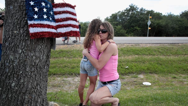 Carissa Potts hugs her 7-year-old daughter Kaylee...